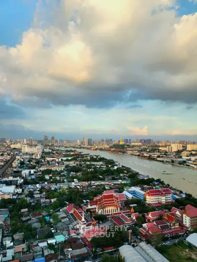 Stunning aerial view of cityscape with river and skyline at sunset, perfect for urban living enthusiasts.