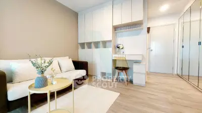 Modern living room with stylish furniture and built-in storage, perfect for urban living.