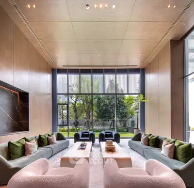 Luxurious and spacious living room with modern decor and large windows offering a stunning garden view.