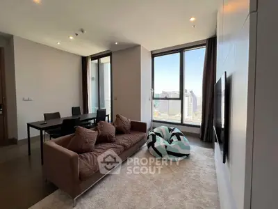 Modern living room with city view, stylish furniture, and large windows.