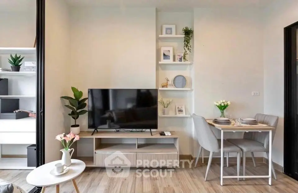 Modern living room with TV, dining area, and stylish decor