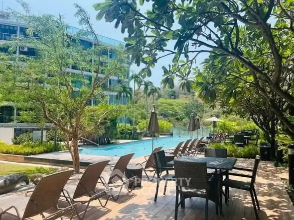Luxurious outdoor pool area with lush greenery and modern seating