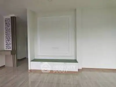 Spacious modern living room with elegant design and ample natural light.