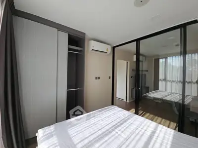 Modern bedroom with large windows and built-in wardrobe