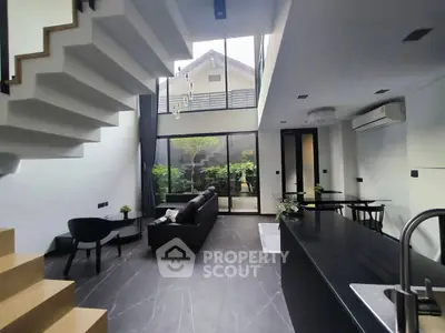 Stunning modern living room with high ceiling and garden view