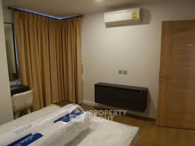 Cozy bedroom with air conditioning and modern furnishings, perfect for comfort and relaxation.