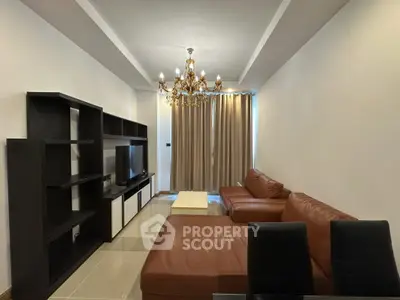 Luxurious living room with elegant chandelier and modern leather sofas