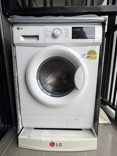 Modern LG washing machine on balcony, ideal for urban living convenience.
