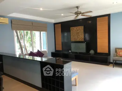 Spacious living room with modern decor and large windows for natural light