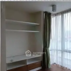 Bright corner unit with large windows and built-in shelving, perfect for modern living.