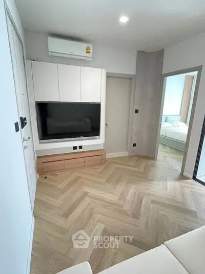 Modern living room with sleek TV setup and stylish wooden flooring