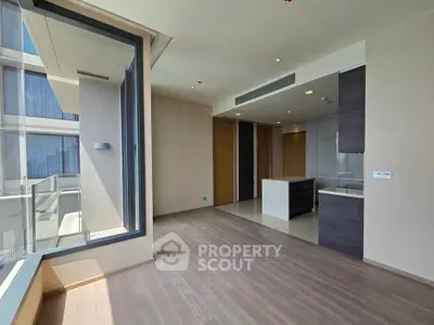Spacious modern apartment with open layout and large windows offering abundant natural light.