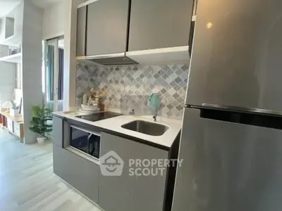 Modern compact kitchen with sleek cabinets and stainless steel appliances