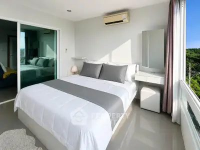 Modern bedroom with large windows and air conditioning, featuring a sleek design and natural light.