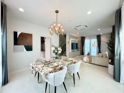 Elegant open-plan living and dining area with modern decor and natural light