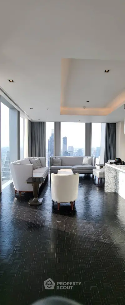 Luxurious high-rise living room with panoramic city views and elegant furnishings.