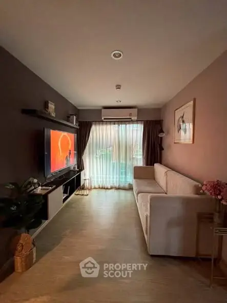 Cozy living room with modern decor and large window for natural light