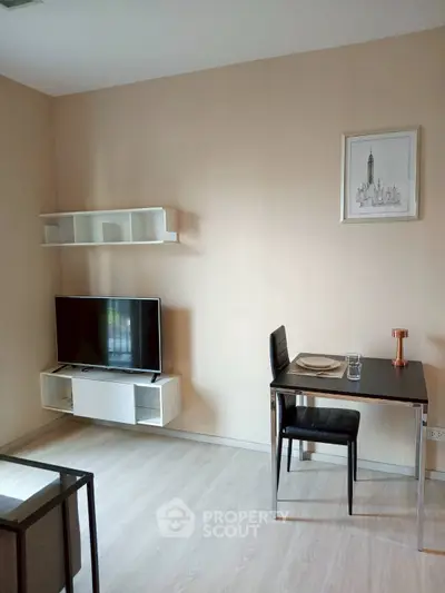 Modern living room with minimalist decor and wall-mounted TV