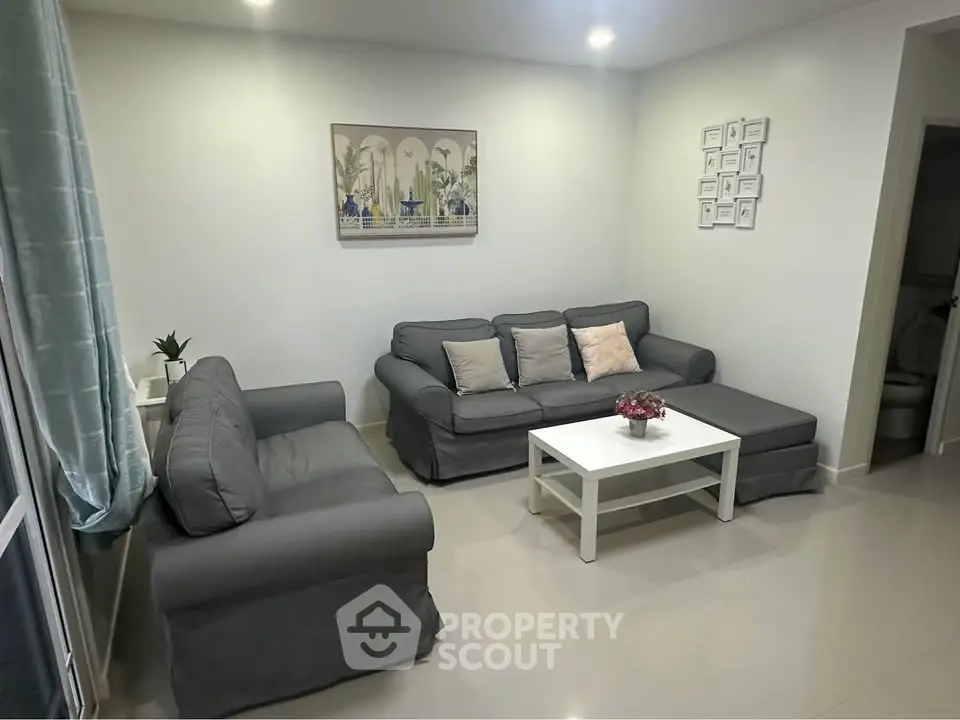 Cozy living room with modern gray sofas and white coffee table