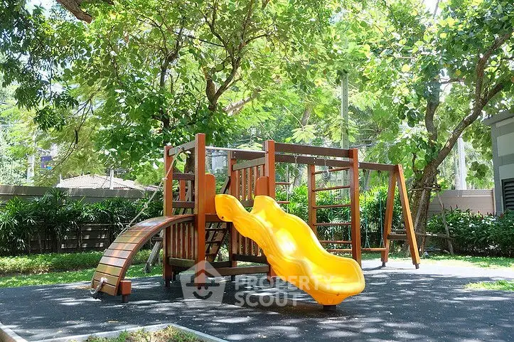 Charming outdoor playground with slide in lush garden setting, perfect for family-friendly living.