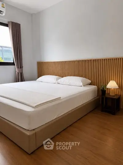 Modern bedroom with stylish wooden headboard and cozy lighting