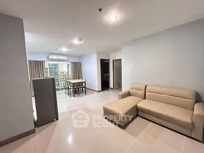 Spacious living room with modern beige sofa and natural light