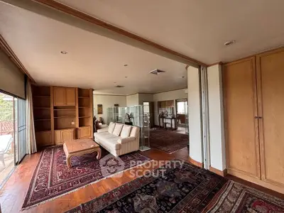 Spacious living room with elegant wooden accents and large windows