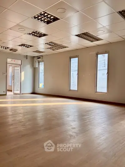 Spacious office space with natural light and modern ceiling design.
