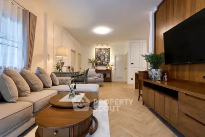 Elegant living room with modern decor and wooden furniture, featuring a cozy seating area and stylish lighting.