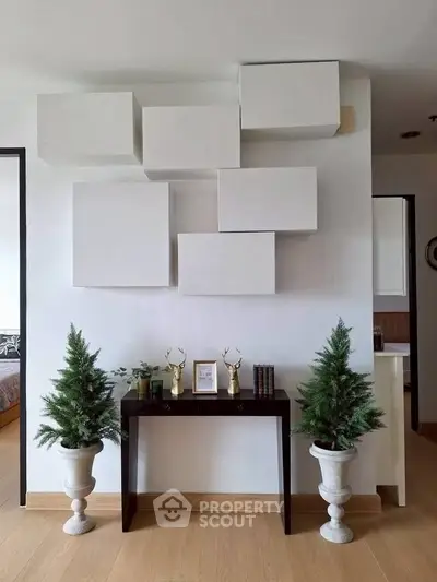 Modern interior with geometric wall art and elegant decor in a stylish living space.