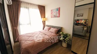 Cozy bedroom with stylish decor and natural light, perfect for relaxation.
