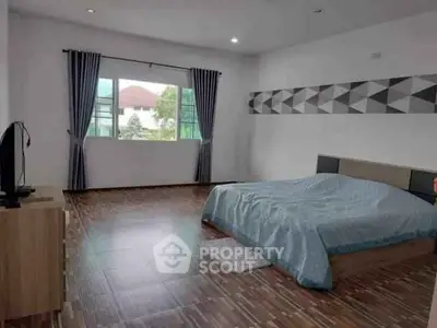 Spacious modern bedroom with large window and stylish decor