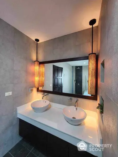 Modern bathroom with dual sinks and elegant lighting