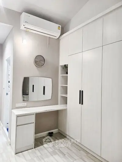 Modern bedroom with built-in wardrobe and air conditioning unit