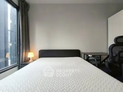 Modern bedroom with large window and minimalist furniture in urban apartment