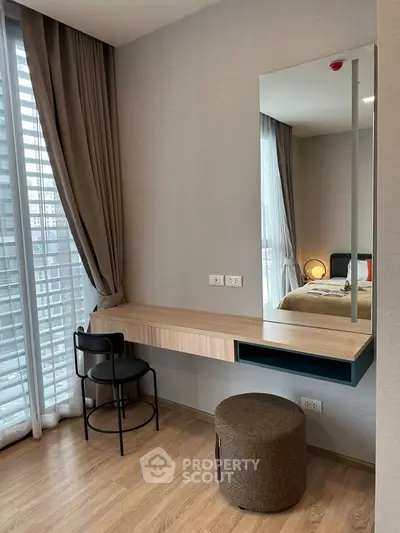 Modern bedroom with stylish vanity and floor-to-ceiling windows