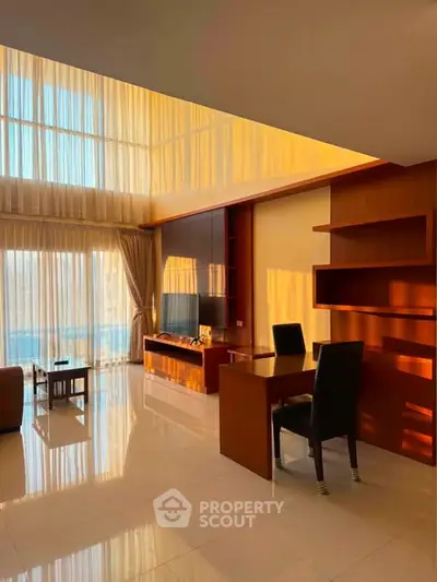Luxurious living room with high ceilings and modern furniture, featuring floor-to-ceiling windows with stunning views.