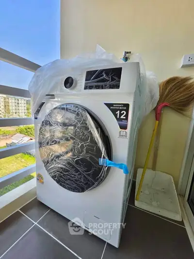 Modern washing machine on a balcony with a scenic view, perfect for urban living convenience.