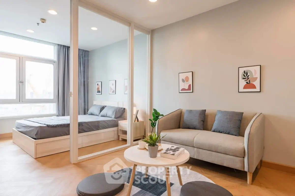 Modern studio apartment with cozy living area and stylish bedroom