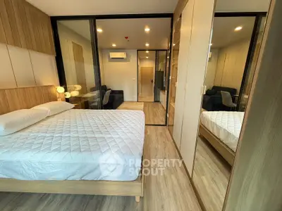 Modern bedroom with mirrored wardrobe and cozy ambiance