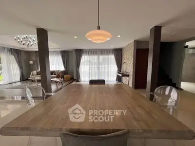 Spacious modern living room with elegant dining area and natural light