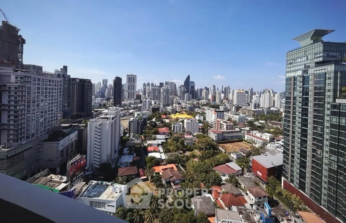 Stunning cityscape view from a high-rise balcony showcasing urban skyline and vibrant city life.