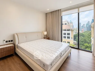 Spacious bedroom with city view and modern furnishings in luxury apartment