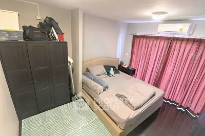 Cozy bedroom with modern decor, featuring a comfortable bed, wardrobe, and air conditioning for ultimate relaxation.