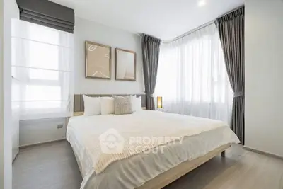 Modern bedroom with large windows and elegant curtains