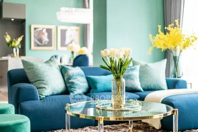 Luxurious living room with vibrant teal decor and elegant furnishings