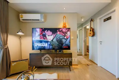 Stylish living room with modern decor, featuring a wall-mounted TV and musical instruments.