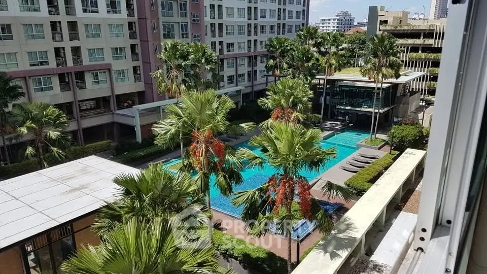 Luxurious condominium with pool view and lush greenery, perfect for urban living.