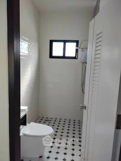 Modern bathroom with white subway tiles and black-and-white checkered floor