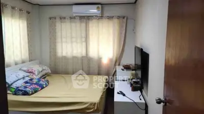 Cozy bedroom with natural light, air conditioning, and modern furnishings for a comfortable living experience.